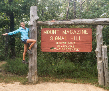 Give yourself goals and celebrate with a photo when you reach them, like running up Mount Magazine to the highest point in Arkansas.