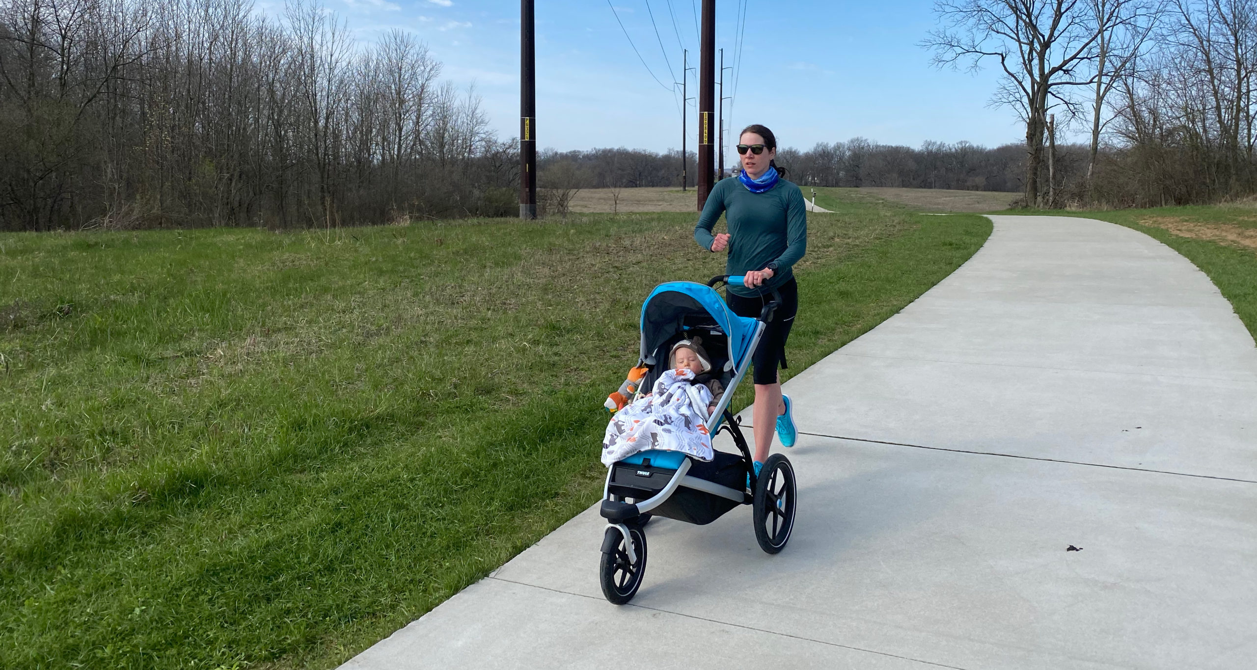 Laura Norris walking with her baby in a stroller, post-partum depression, mental health, depression recovery, coping with mental illness