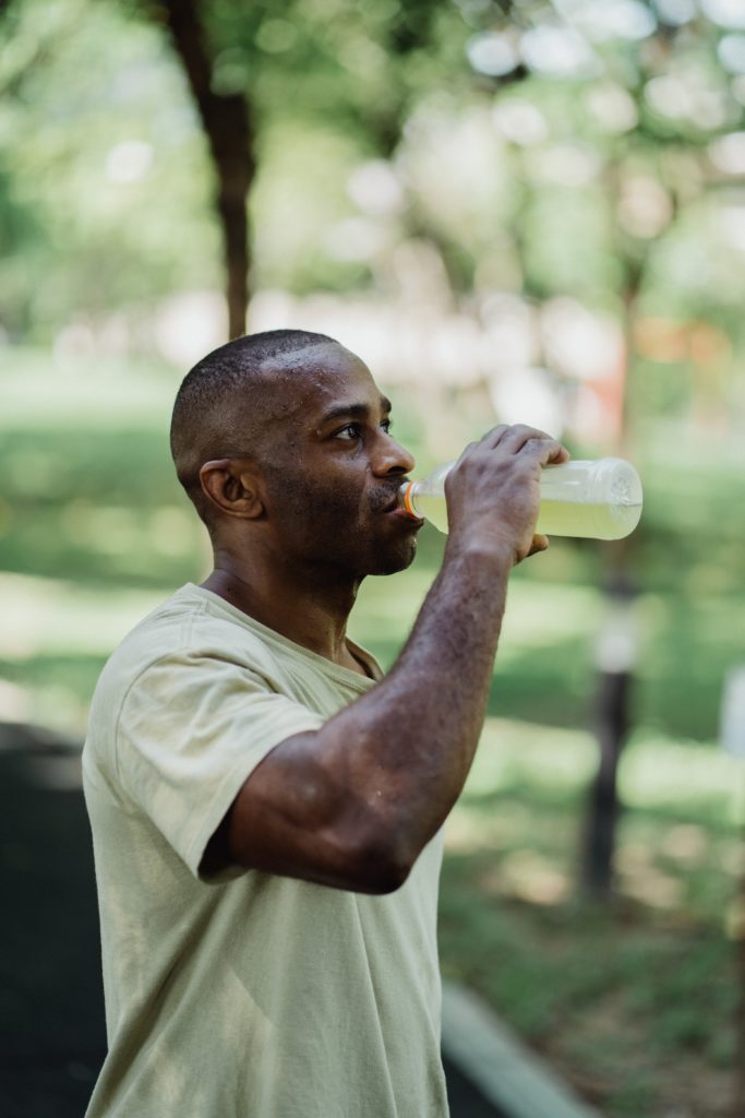 Man drinking water, fueling on race day, running nutrition