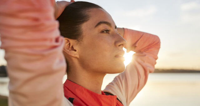 Woman looking forward with her hands on her head, running roadblocks, hitting a plateau with running, running plateau, mindful running, mental barriers running