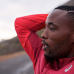Close up of man in red athletic top taking a break from a run, mental roadblocks, running roadblocks, running and mental health, running and anxiety